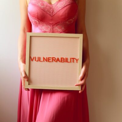 Photo by Ava Sol - Lina Hadid Woman holds a sign that reads "vulnerability".