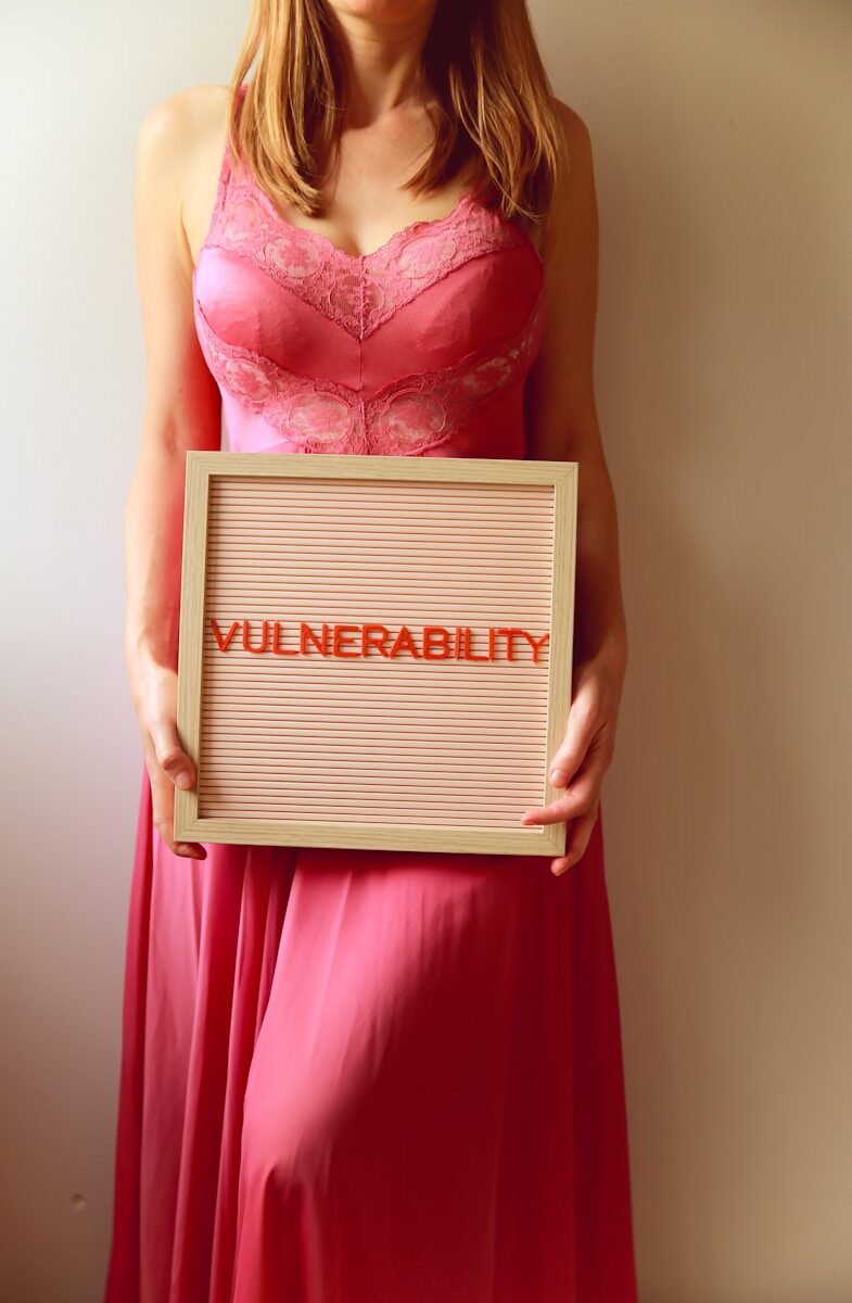 Woman holds a sign that reads "vulnerability".